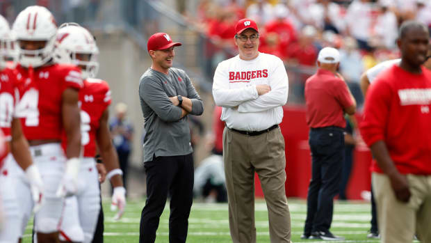 Wisconsin head coach Paul Chryst speaking with Washington State head coach Jake Dickert ahead of their contest on Saturday.